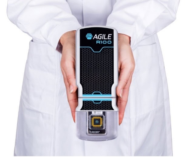 Researcher holding the Agile R100 device