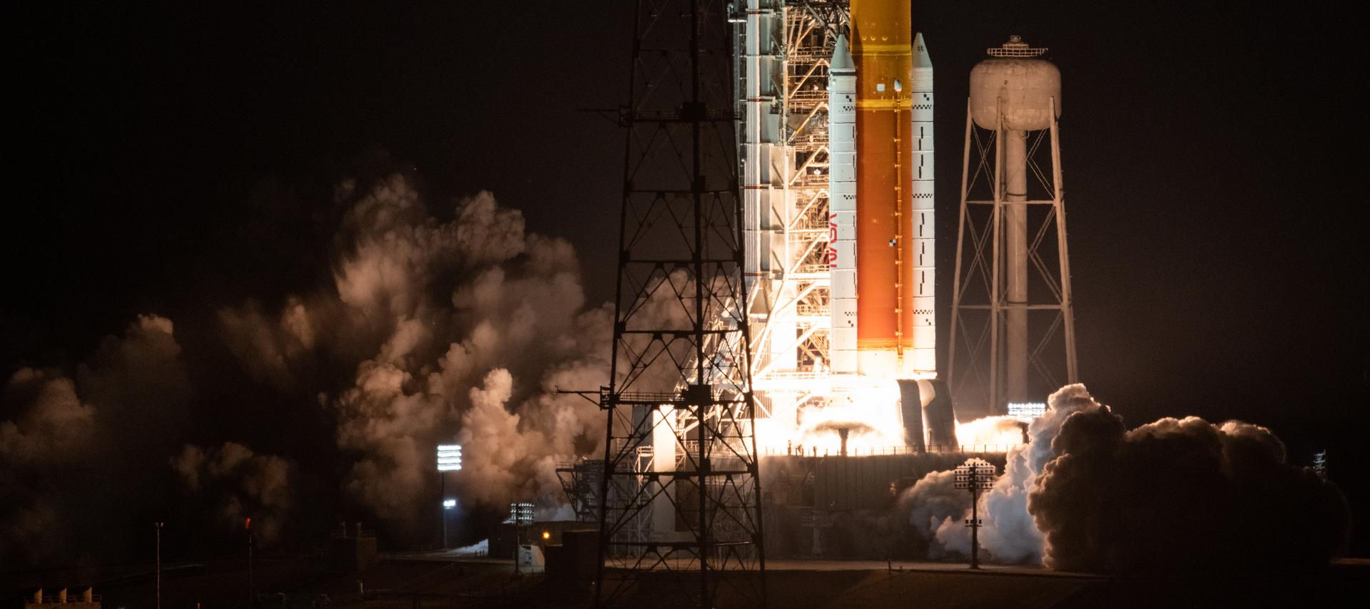 NASA's Artemis I SLS rocket lifting off at night from Launch Pad 39B at Kennedy Space Center